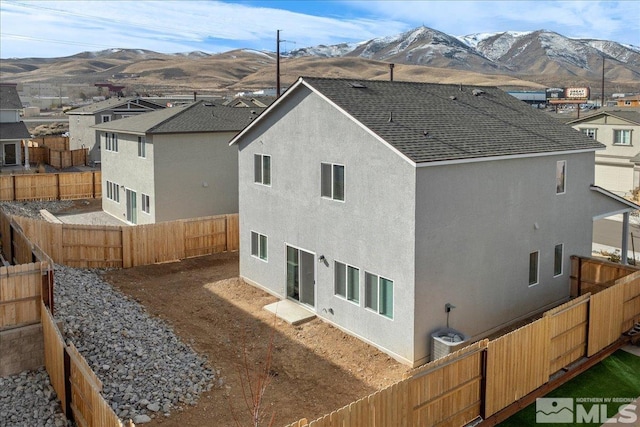 rear view of property featuring a mountain view