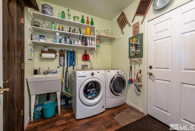 laundry area featuring dark wood-type flooring and washing machine and clothes dryer