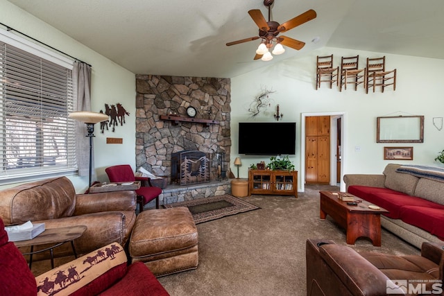 living room featuring a fireplace, vaulted ceiling, ceiling fan, and carpet flooring