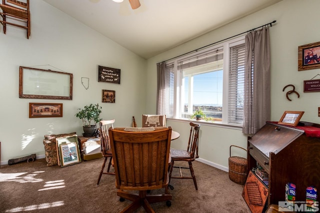 dining area featuring ceiling fan, carpet flooring, and vaulted ceiling