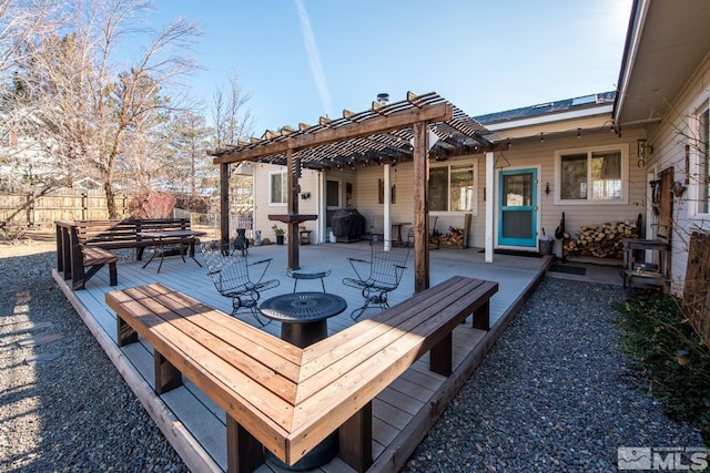 view of patio with area for grilling and a pergola