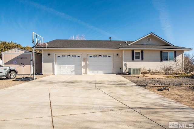 ranch-style house with a garage, cooling unit, and a storage unit