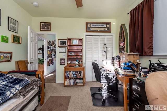 carpeted bedroom with ceiling fan and a closet