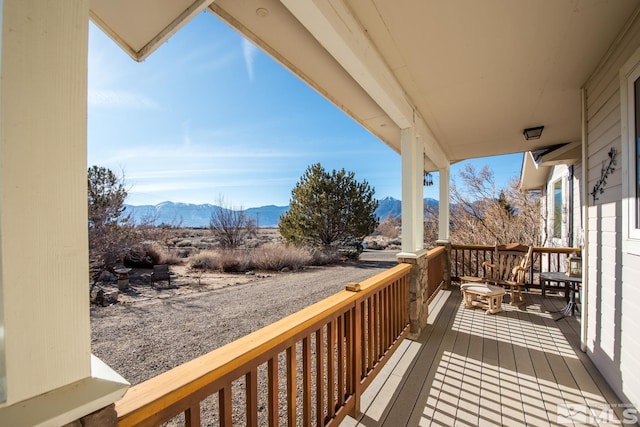 wooden deck with a mountain view