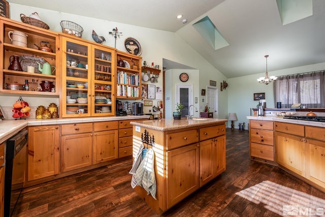 kitchen featuring decorative light fixtures, a chandelier, dark hardwood / wood-style floors, stainless steel gas stovetop, and vaulted ceiling with skylight