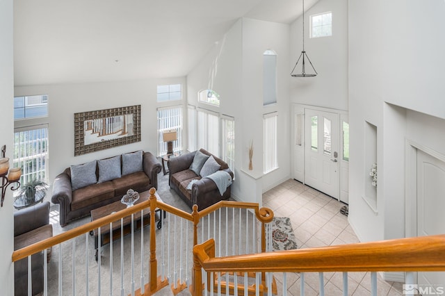 tiled foyer entrance featuring high vaulted ceiling