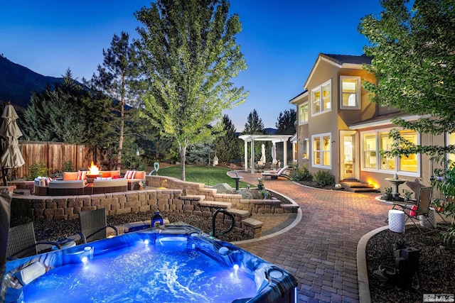 pool at dusk featuring a hot tub, a patio, and an outdoor fire pit