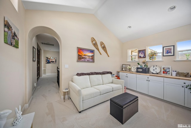 carpeted living room with vaulted ceiling