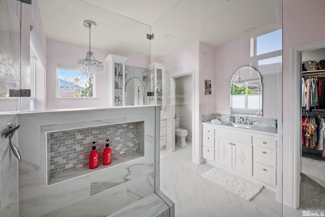 bathroom featuring vanity, a wealth of natural light, backsplash, and toilet