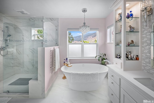 bathroom with vanity, independent shower and bath, and an inviting chandelier