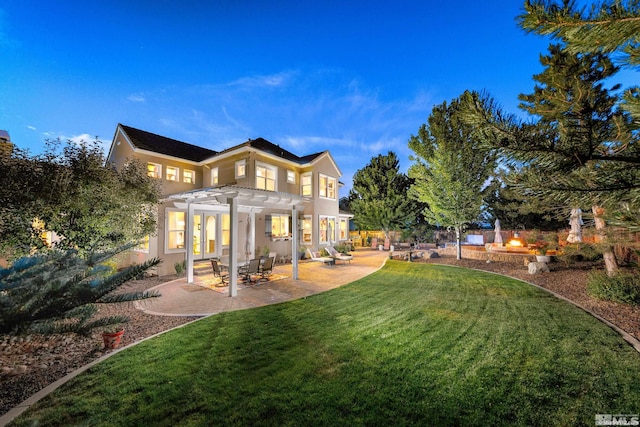 yard at dusk featuring a patio and a pergola