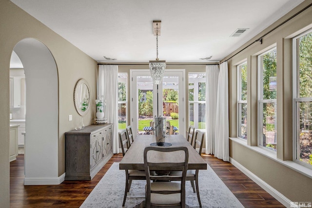 dining room featuring dark hardwood / wood-style flooring and a chandelier