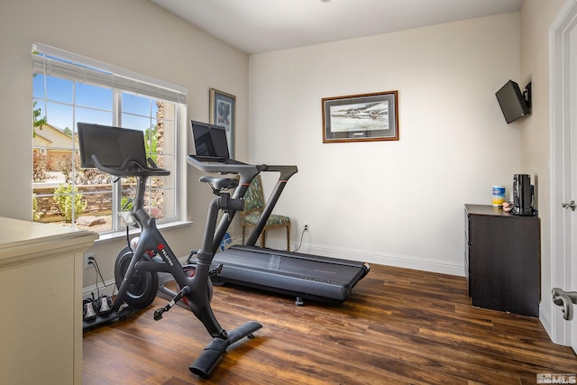 workout area with dark hardwood / wood-style floors