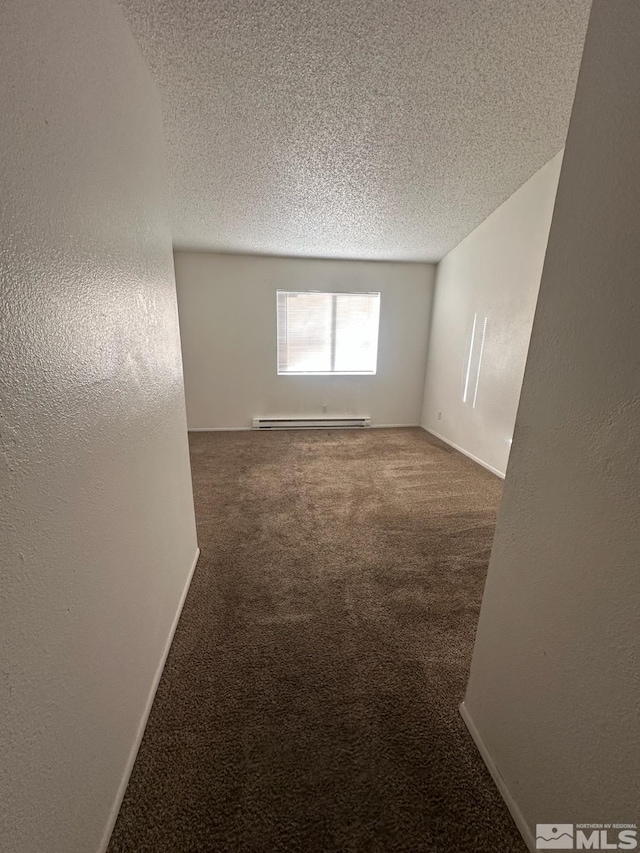 unfurnished room featuring a baseboard heating unit, a textured ceiling, and carpet