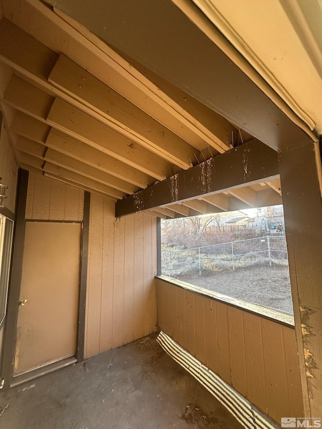 basement featuring wood walls