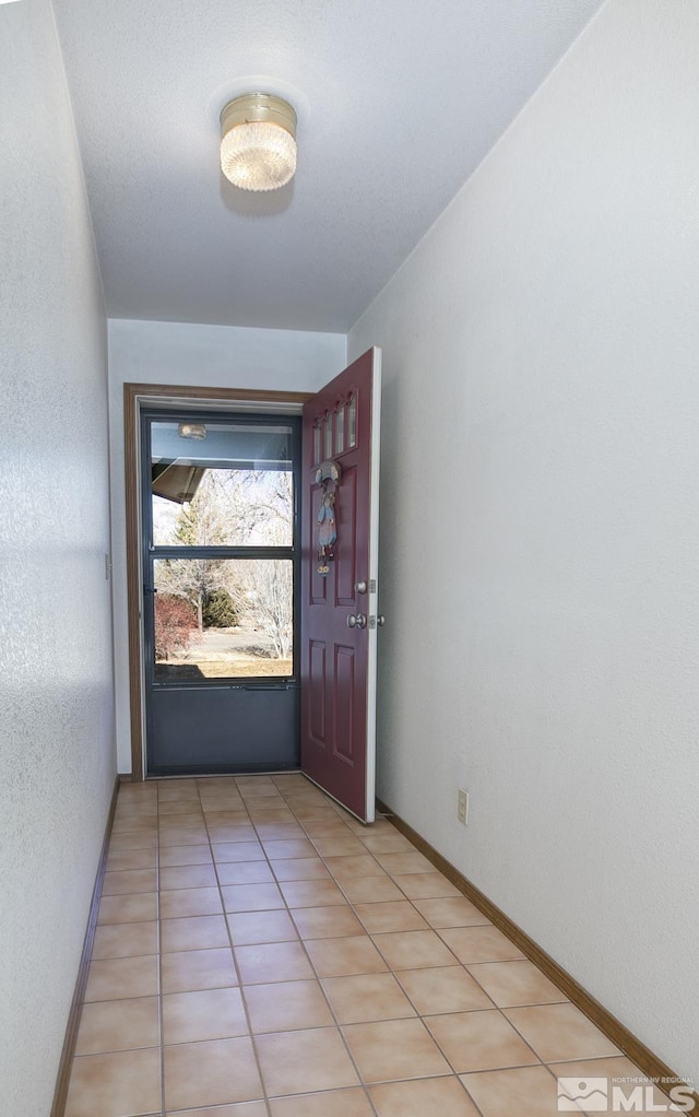 doorway with light tile patterned floors