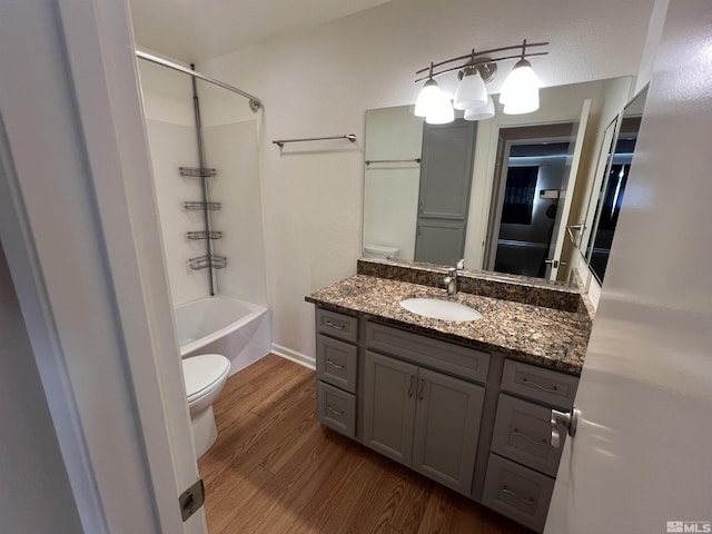 full bathroom featuring hardwood / wood-style flooring, vanity, toilet, and tub / shower combination