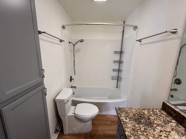 full bathroom featuring vanity, wood-type flooring, bathtub / shower combination, and toilet