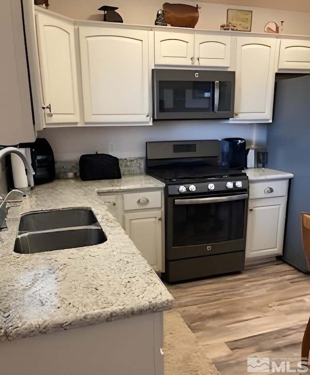 kitchen featuring appliances with stainless steel finishes and white cabinets