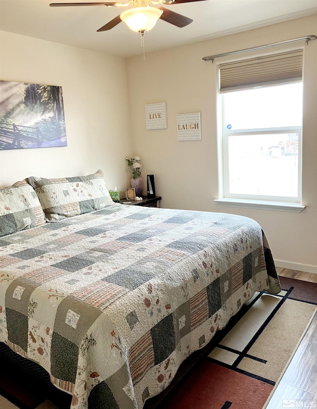 bedroom featuring hardwood / wood-style flooring and ceiling fan