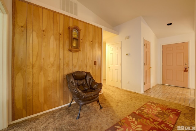 unfurnished room with lofted ceiling and light carpet