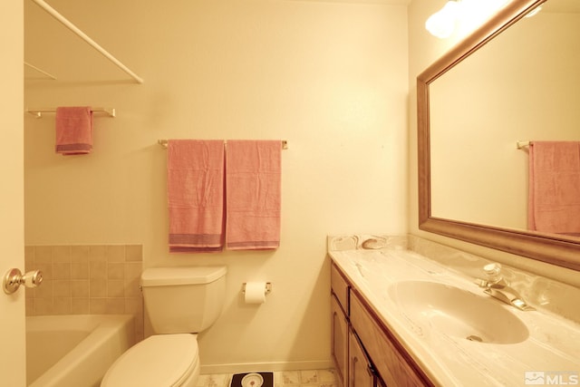 bathroom featuring vanity, a bath, and toilet