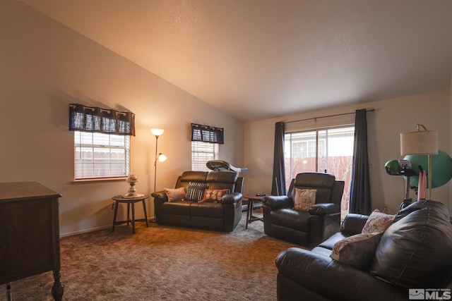 carpeted living room with vaulted ceiling