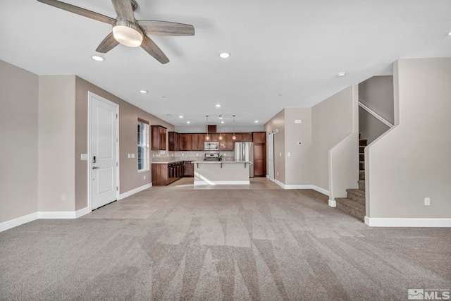 unfurnished living room with light carpet and ceiling fan