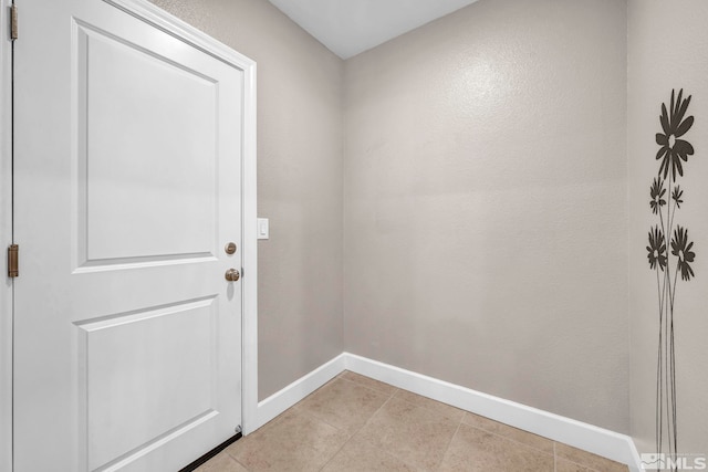 doorway to outside with light tile patterned floors