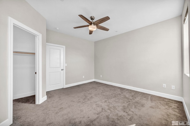 unfurnished bedroom featuring dark colored carpet, ceiling fan, and a closet