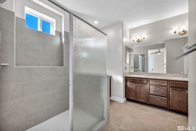 bathroom with ceiling fan, vanity, and an enclosed shower