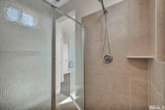 bathroom featuring a shower with door