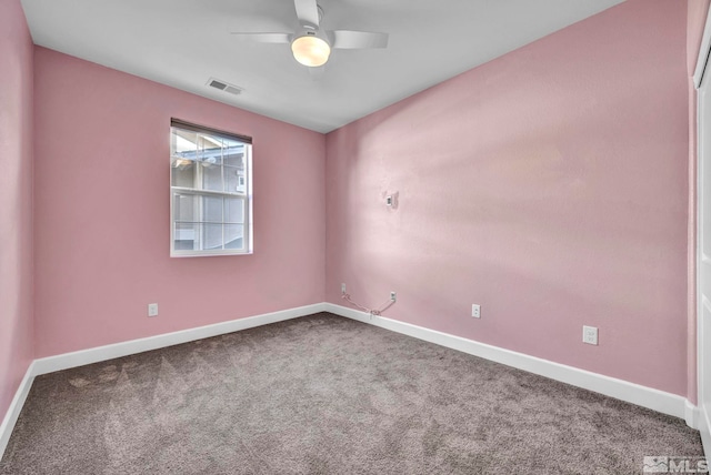 empty room with ceiling fan and carpet