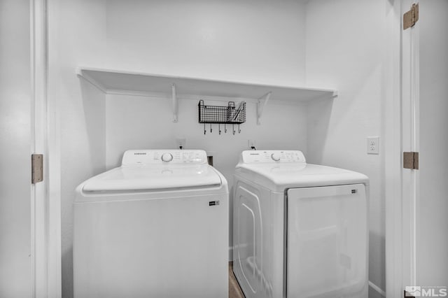 laundry room with washing machine and clothes dryer