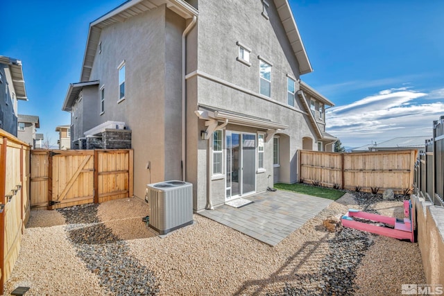 back of house with central AC and a patio