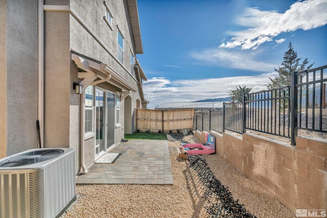 exterior space with central AC unit and a patio area