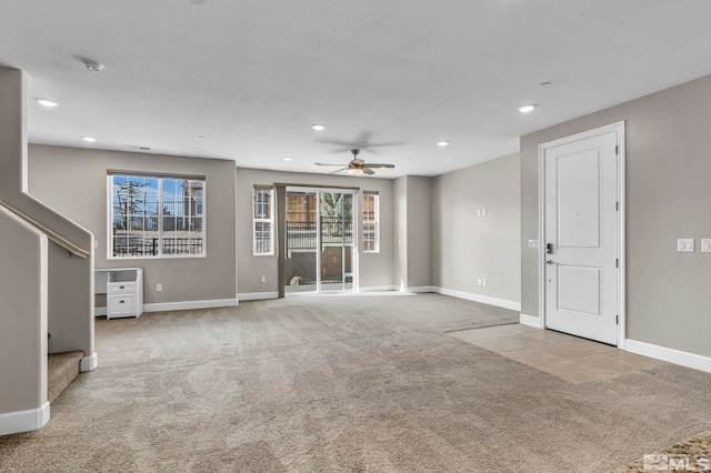 unfurnished living room with light carpet and ceiling fan