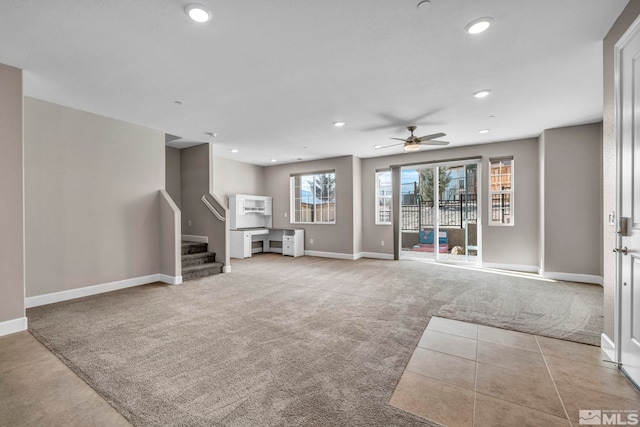 unfurnished living room featuring ceiling fan and light carpet