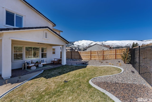 view of yard with a mountain view and a patio