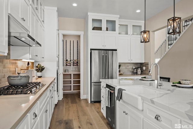 kitchen with pendant lighting, white cabinetry, and appliances with stainless steel finishes