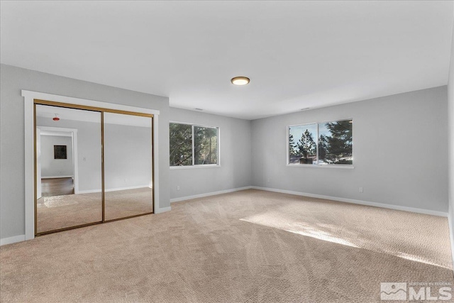 unfurnished bedroom with light colored carpet