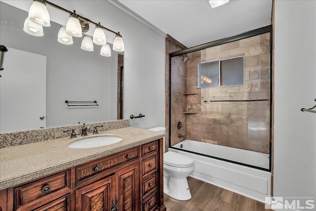 full bathroom with enclosed tub / shower combo, vanity, toilet, and hardwood / wood-style floors