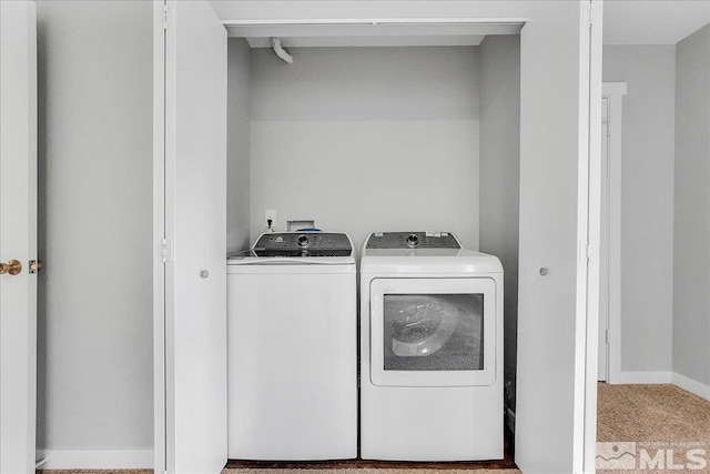 washroom with light colored carpet and washing machine and dryer