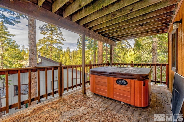 wooden deck featuring a hot tub