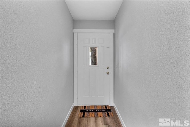 doorway with hardwood / wood-style floors