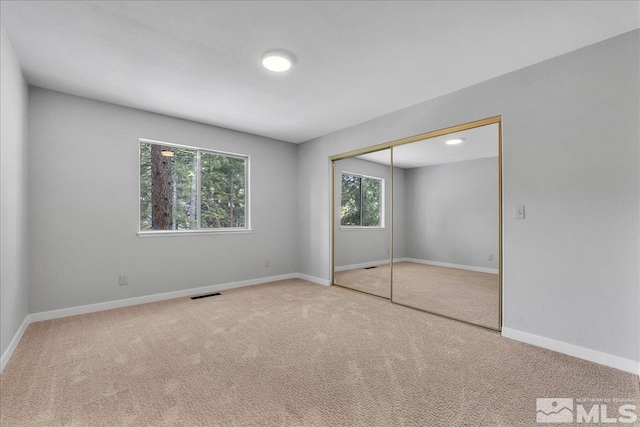 unfurnished bedroom featuring a closet and carpet