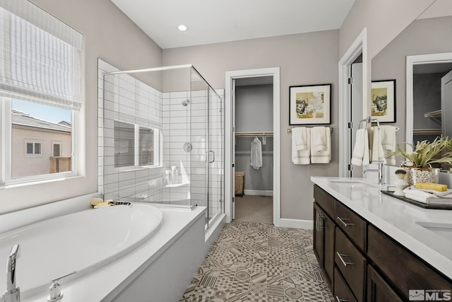 bathroom with tile patterned floors, separate shower and tub, and vanity