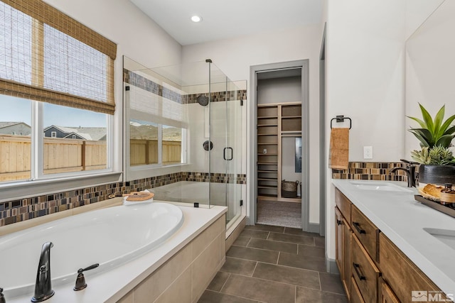 bathroom featuring vanity, shower with separate bathtub, and tile patterned flooring