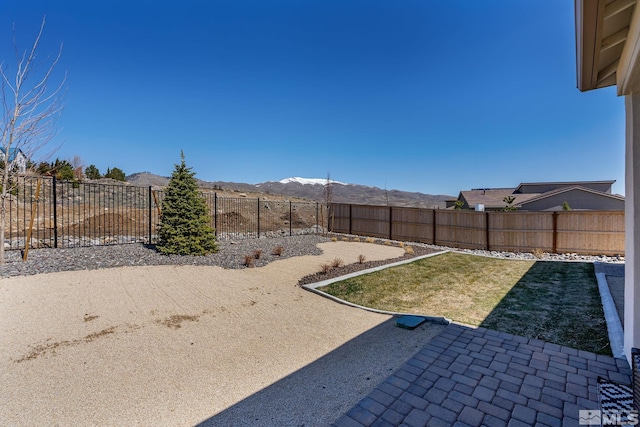 view of yard featuring a mountain view and a patio area