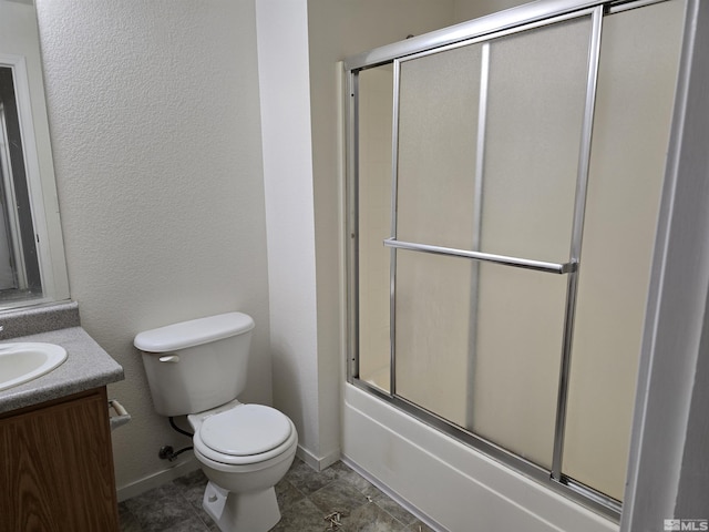 full bathroom with vanity, shower / bath combination with glass door, and toilet